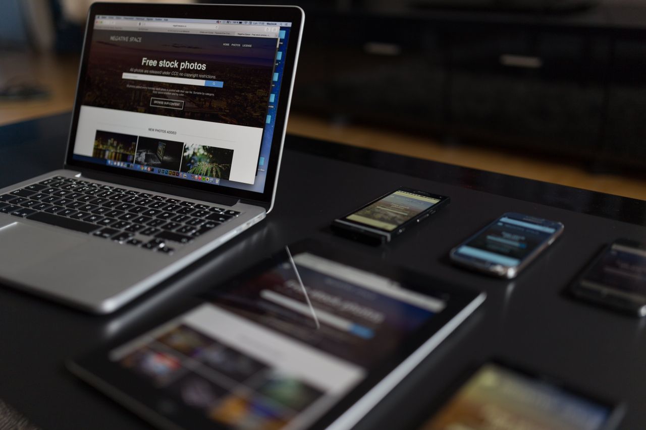 A modern workspace featuring a laptop, tablet, and smartphones, well suited to tech and freelance work.